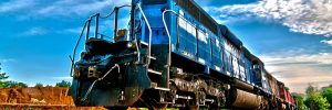 Blue locomotive on rail tracks