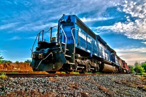 Blue locomotive on rail tracks