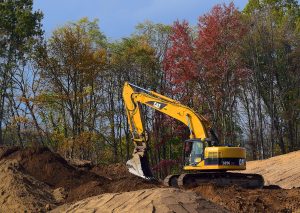 Excavator digging in woods