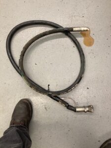 leaking hydraulic hose on floor