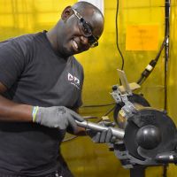 PDI employee grinding the end of a tube at the Buffalo manufacturing facility