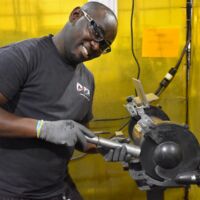 PDI employee grinding the end of a tube at the Buffalo manufacturing facility