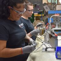 Two PDI employees assembling hose-tube combinations at the Buffalo manufacturing facility