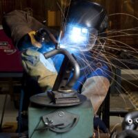 Welder in PDI Erie, PA manufacturing facility manufacturing a steel tube